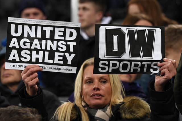 Newcastle fan holds up ‘United Against Ashley’ cards during the Premier League match between Newcastle United and Manchester City at St. James Park in 2019 