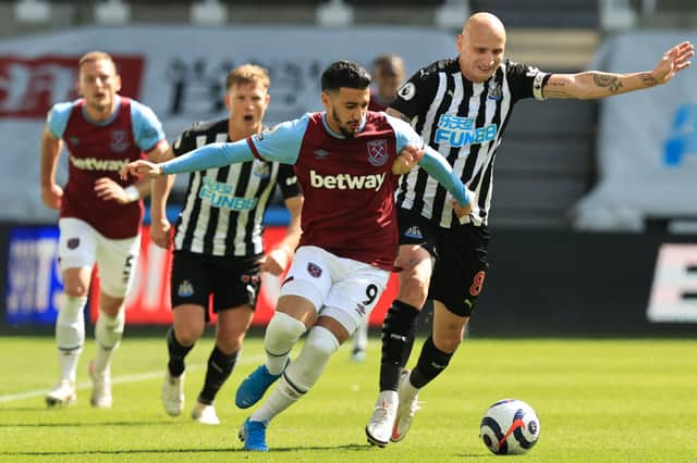 West Ham United’s Algerian midfielder Said Benrahma (L) fights for the ball with Newcastle United’s English midfielder Jonjo Shelvey (R) during the English Premier League football match between Newcastle United and West Ham United at St James’ Park in Newcastle-upon-Tyne, north east England on April 17, 2021.