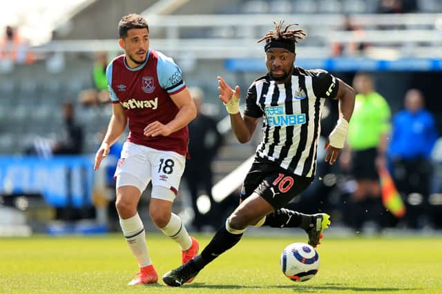 Allan Saint-Maximin of Newcastle United is challenged by Pablo Fornals of West Ham United during the Premier League match between Newcastle United and West Ham United at St. James Park on April 17, 2021 in Newcastle upon Tyne, England. 