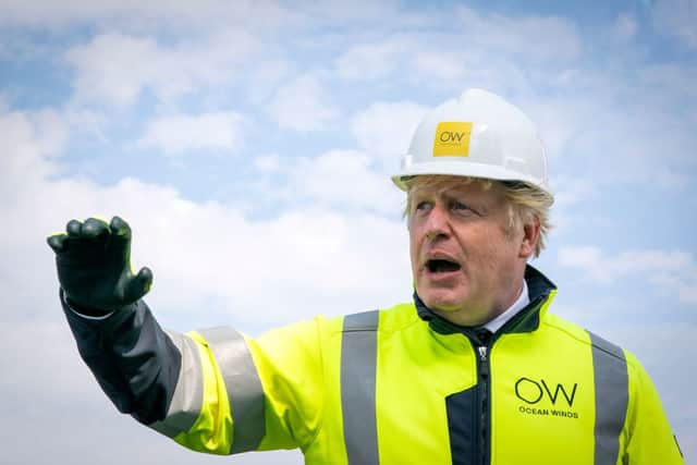 Britain’s Prime Minister Boris Johnson gestures onboard the Esvagt Alba during a visit to the Moray Offshore Windfarm East, off the Aberdeenshire coast on August 5, 2021, the second day of his two-day visit to Scotland. 