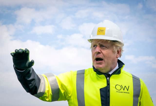Britain’s Prime Minister Boris Johnson gestures onboard the Esvagt Alba during a visit to the Moray Offshore Windfarm East, off the Aberdeenshire coast on August 5, 2021, the second day of his two-day visit to Scotland. 
