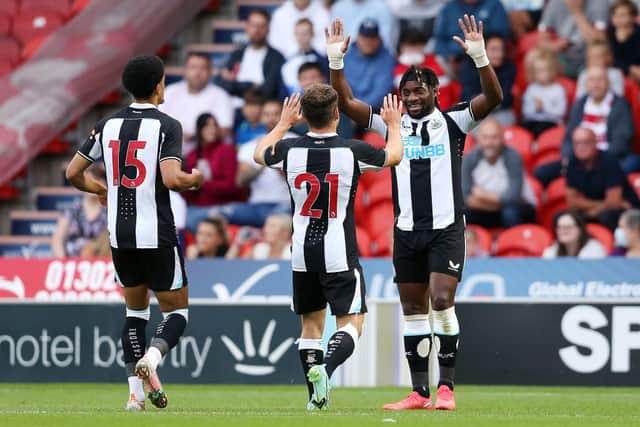 Ryan Fraser of Newcastle United celebrates with team mate Allan Saint-Maximin after scoring his team’s first goal during the Pre-Season Friendly match between Doncaster Rovers and Newcastle United at at Keepmoat Stadium on July 23, 2021 in Doncaster, England.