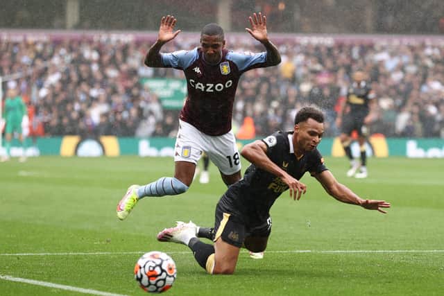 Jacob Murphy of Newcastle United goes down after a challenge from Ashley Young of Aston Villa during the Premier League match between Aston Villa and Newcastle United at Villa Park on August 21, 2021 in Birmingham, England.
