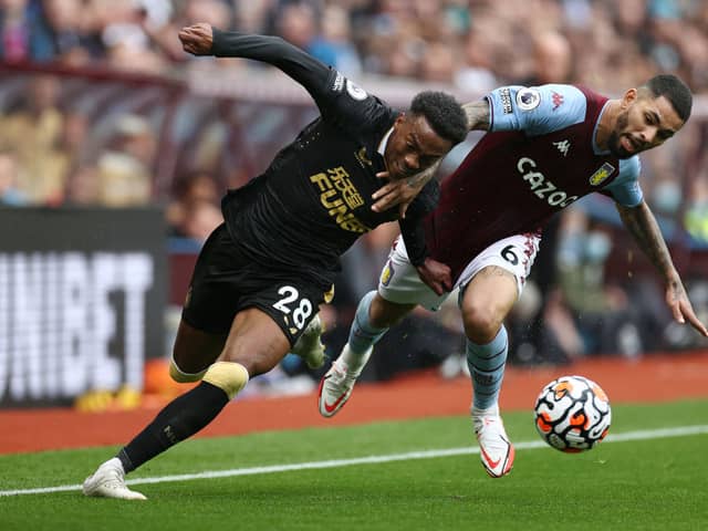 Douglas Luiz of Aston Villa battles for possession with Joe Willock of Newcastle United during the Premier League match between Aston Villa and Newcastle United at Villa Park on August 21, 2021 in Birmingham, England. 