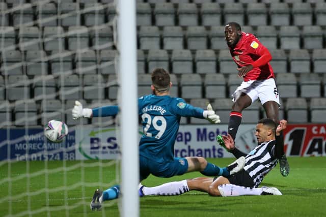 Newcastle United’s English goalkeeper Mark Gillespie (L) saves this shot from Morecambe’s French midfielder Toumani Diagouraga (R) during the English League Cup third round football match between Morecambe and Newcastle United at The Mazuma Stadium in north-west England, on September 23, 2020. 