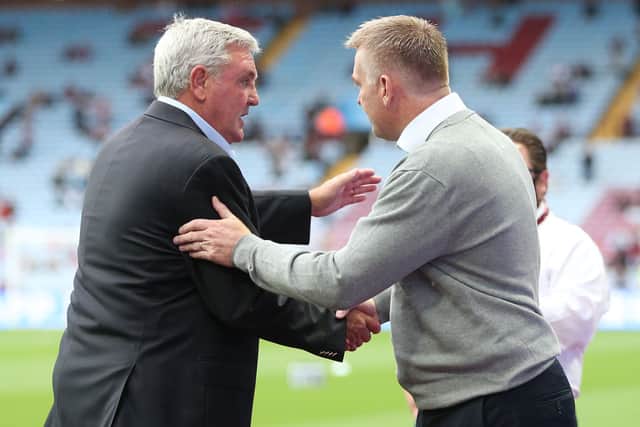 Steve Bruce, Manager of Newcastle United greets Dean Smith, Manager of Aston Villa prior to the Premier League match between Aston Villa and Newcastle United at Villa Park on August 21, 2021 in Birmingham, England.