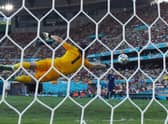 Slovakia’s goalkeeper Martin Dubravka dives to save a goal during the UEFA EURO 2020 Group E football match between Slovakia and Spain at La Cartuja Stadium in Seville on June 23, 2021. 