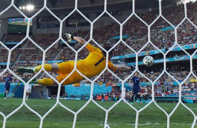 <p>Slovakia’s goalkeeper Martin Dubravka dives to save a goal during the UEFA EURO 2020 Group E football match between Slovakia and Spain at La Cartuja Stadium in Seville on June 23, 2021. </p>