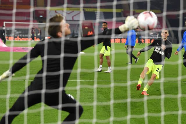 Newcastle coach Stephen Clemence (r) looks on as Miguel Almiron takes a shot at Mark Gillespie during the warm up before the Premier League match between Southampton and Newcastle United at St Mary’s Stadium on November 06, 2020 in Southampton, England.