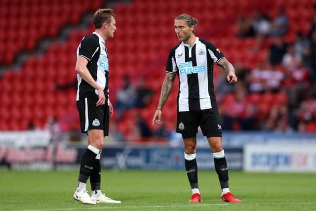 Jeff Hendrick interacts with Sean Longstaff of Newcastle United during the Pre-Season Friendly match between Doncaster Rovers and Newcastle United at at Keepmoat Stadium on July 23, 2021 in Doncaster, England. 