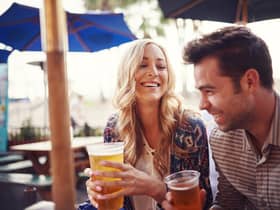 Couple enjoy a drink in a sunny beer garden. (Pic: Shutterstock)