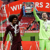 Hamza Choudhury (L) and Danny Ward of Leicester City lift the Emirates FA Cup Trophy following The Emirates FA Cup Final match between Chelsea and Leicester City at Wembley Stadium on May 15, 2021 in London, England. 