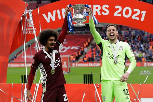 Hamza Choudhury (L) and Danny Ward of Leicester City lift the Emirates FA Cup Trophy following The Emirates FA Cup Final match between Chelsea and Leicester City at Wembley Stadium on May 15, 2021 in London, England. 