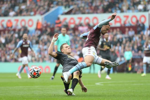 Matthew Cash of Aston Villa is challenged by Matt Ritchie of Newcastle United during the Premier League match between Aston Villa and Newcastle United at Villa Park on August 21, 2021 in Birmingham, England. 