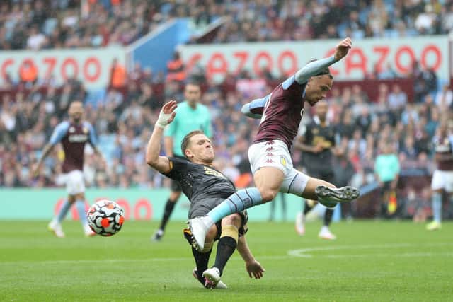 Matthew Cash of Aston Villa is challenged by Matt Ritchie of Newcastle United during the Premier League match between Aston Villa and Newcastle United at Villa Park on August 21, 2021 in Birmingham, England.