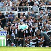 Callum Wilson of Newcastle United receives medical attention during the Premier League match between Newcastle United  and  Southampton at St. James Park on August 28, 2021 in Newcastle upon Tyne, England. 