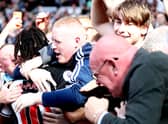 Allan Saint-Maximin of Newcastle United celebrates after scoring their side’s second goal with the fans during the Premier League match between Newcastle United  and  Southampton at St. James Park on August 28, 2021 in Newcastle upon Tyne, England.