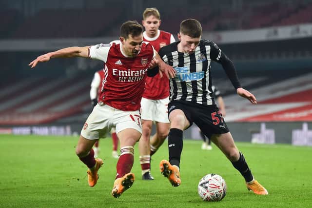 Arsenal’s German-born Portuguese defender Cedric Soares (L) vies with Newcastle United’s English midfielder Elliot Anderson (R) during the English FA Cup third round football match between Arsenal and Newcastle United at the Emirates Stadium in London on January 9, 2021.