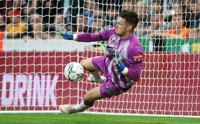 Freddie Woodman of Newcastle United saves a penalty in the shootout during the Carabao Cup Second Round match between Newcastle United and Burnley at St. James Park on August 25, 2021 in Newcastle upon Tyne, England. 