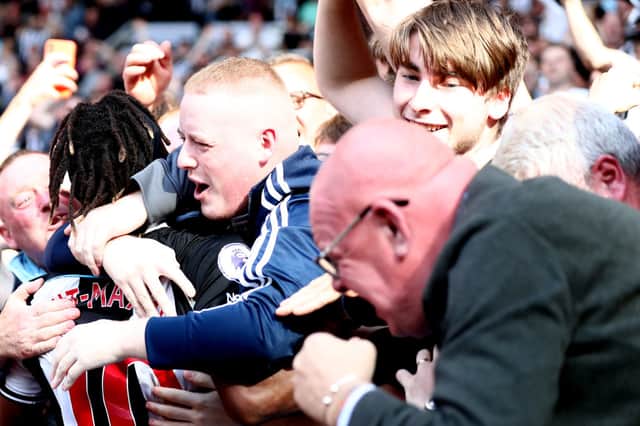 Allan Saint-Maximin of Newcastle United celebrates after scoring their side’s second goal with the fans during the Premier League match between Newcastle United  and  Southampton at St. James Park on August 28, 2021 in Newcastle upon Tyne, England. 