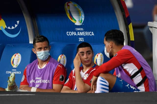 Paraguay’s Miguel Almiron (C) speaks with teammates after leaving the field due to an injury during the Conmebol Copa America 2021 football tournament group phase match between Uruguay and Paraguay at the Nilton Santos Stadium in Rio de Janeiro, Brazil, on June 28, 2021.