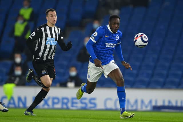 Danny Welbeck of Brighton & Hove Albion gets away from Javi Manquillo of Newcastle United during the Premier League match between Brighton & Hove Albion and Newcastle United at American Express Community Stadium on March 20, 2021 in Brighton, England.