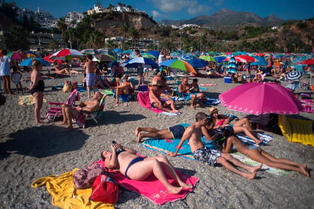 Sunbathers enjoy a beach near Malaga (Image: Getty Images)