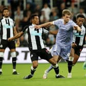 Isaac Hayden of Newcastle United and Patrick Bamford of Leeds United  battle for the ball  during the Premier League match between Newcastle United and Leeds United at St. James Park on September 17, 2021 in Newcastle upon Tyne, England.