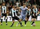 Isaac Hayden of Newcastle United and Patrick Bamford of Leeds United  battle for the ball  during the Premier League match between Newcastle United and Leeds United at St. James Park on September 17, 2021 in Newcastle upon Tyne, England.