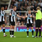 Ryan Fraser of Newcastle United appeals to referee Mike Dean during the Premier League match between Newcastle United and Leeds United at St. James Park on September 17, 2021 in Newcastle upon Tyne, England.