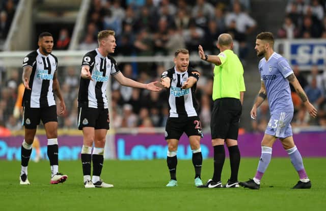 Ryan Fraser of Newcastle United appeals to referee Mike Dean during the Premier League match between Newcastle United and Leeds United at St. James Park on September 17, 2021 in Newcastle upon Tyne, England.