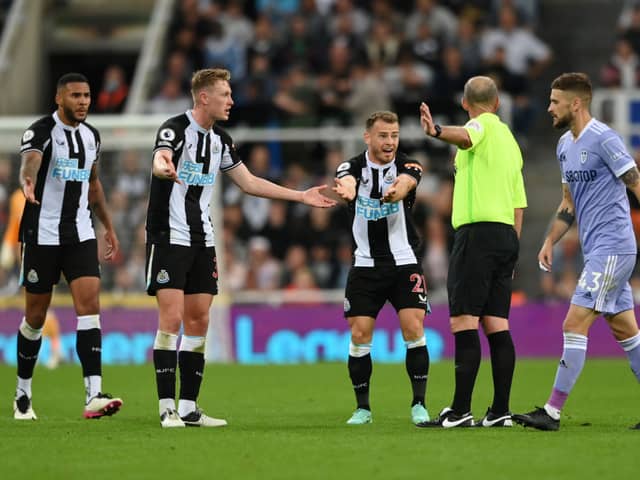 Ryan Fraser of Newcastle United appeals to referee Mike Dean during the Premier League match between Newcastle United and Leeds United at St. James Park on September 17, 2021 in Newcastle upon Tyne, England.