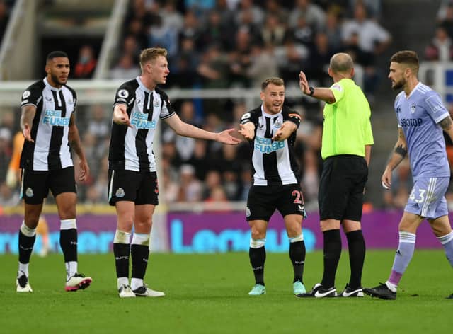 Ryan Fraser of Newcastle United appeals to referee Mike Dean during the Premier League match between Newcastle United and Leeds United at St. James Park on September 17, 2021 in Newcastle upon Tyne, England.