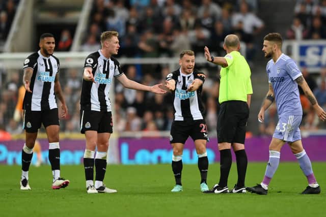 Ryan Fraser of Newcastle United appeals to referee Mike Dean during the Premier League match between Newcastle United and Leeds United at St. James Park on September 17, 2021 in Newcastle upon Tyne, England.