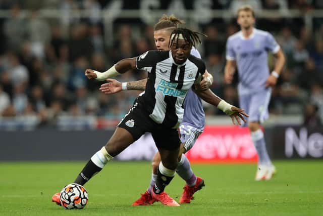 Kalvin Phillips of Leeds United vies with Allan Saint- Maximim of Newcastle United during the Premier League match between Newcastle United and Leeds United at St. James Park on September 17, 2021 in Newcastle upon Tyne, England.