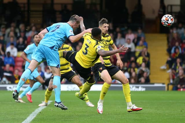 Ciaran Clark of Newcastle United has a headed shot whilst under pressure from Danny Rose of Watford FC during the Premier League match between Watford and Newcastle United at Vicarage Road on September 25, 2021 in Watford, England. 
