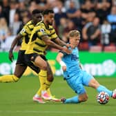 Joshua King of Watford FC with Matt Ritchie of Newcastle United  during the Premier League match between Watford and Newcastle United at Vicarage Road on September 25, 2021 in Watford, England. 
