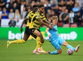 Joshua King of Watford FC with Matt Ritchie of Newcastle United  during the Premier League match between Watford and Newcastle United at Vicarage Road on September 25, 2021 in Watford, England. 