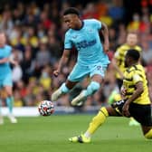 Joe Willock of Newcastle United battles for possession with Danny Rose of Watford FC   during the Premier League match between Watford and Newcastle United at Vicarage Road on September 25, 2021 in Watford, England.