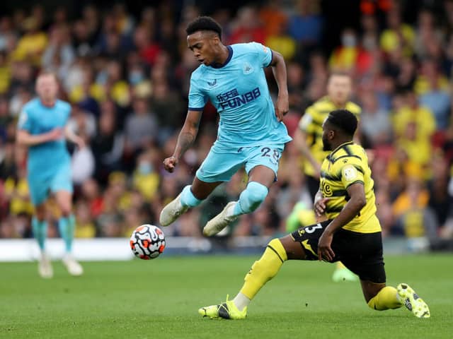 Joe Willock of Newcastle United battles for possession with Danny Rose of Watford FC   during the Premier League match between Watford and Newcastle United at Vicarage Road on September 25, 2021 in Watford, England.