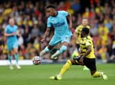 Joe Willock of Newcastle United battles for possession with Danny Rose of Watford FC   during the Premier League match between Watford and Newcastle United at Vicarage Road on September 25, 2021 in Watford, England.