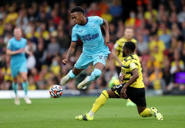 Joe Willock of Newcastle United battles for possession with Danny Rose of Watford FC during the Premier League match between Watford and Newcastle United at Vicarage Road on September 25, 2021 in Watford, England.