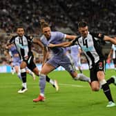 Ciaran Clark of Newcastle United holds off Luke Ayling of Leeds United during the Premier League match between Newcastle United and Leeds United at St. James Park on September 17, 2021 in Newcastle upon Tyne, England.