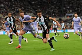 Ciaran Clark of Newcastle United holds off Luke Ayling of Leeds United during the Premier League match between Newcastle United and Leeds United at St. James Park on September 17, 2021 in Newcastle upon Tyne, England.
