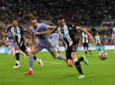 Ciaran Clark of Newcastle United holds off Luke Ayling of Leeds United during the Premier League match between Newcastle United and Leeds United at St. James Park on September 17, 2021 in Newcastle upon Tyne, England.