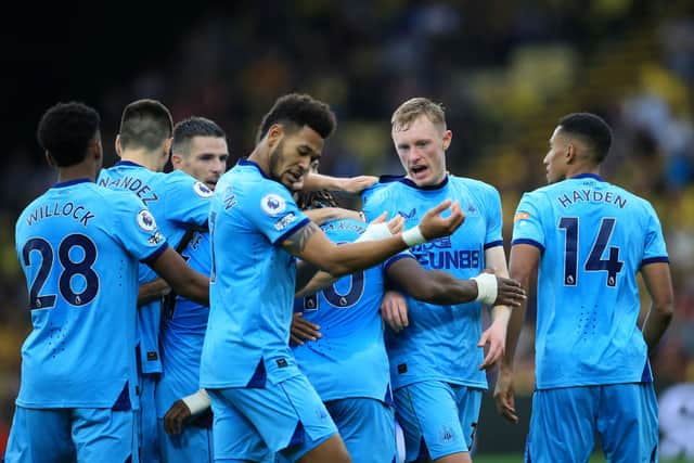 Sean Longstaff of Newcastle United celebrates scoring his sides first goal with team mates during the Premier League match between Watford and Newcastle United at Vicarage Road on September 25, 2021 in Watford, England.