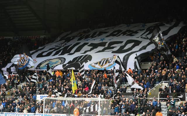 Fans of Newcastle United unvail a giant flag in the stand during the Premier League match between Newcastle United and Huddersfield Town at St. James Park on March 31, 2018 in Newcastle upon Tyne, England.