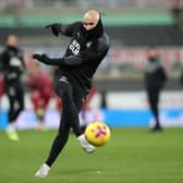 Jonjo Shelvey of Newcastle United warms up prior to the Premier League match between Newcastle United and Liverpool at St. James’ Park on December 30, 2020 in Newcastle upon Tyne, England. The match will be played without fans, behind closed doors as a Covid-19 precaution. 