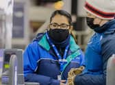 A member of Northern Rail staff helping a customer (Pic from Northern) 