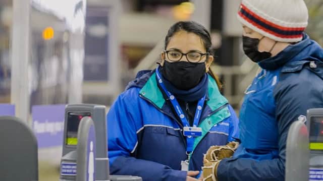 A member of Northern Rail staff helping a customer (Pic from Northern)
